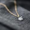 Herkimer-Charm-with-Satellite-Chain-in-Gold-Grey-Jacket-Square